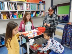 The Green Team Helping a First Grade Class with Breakfast